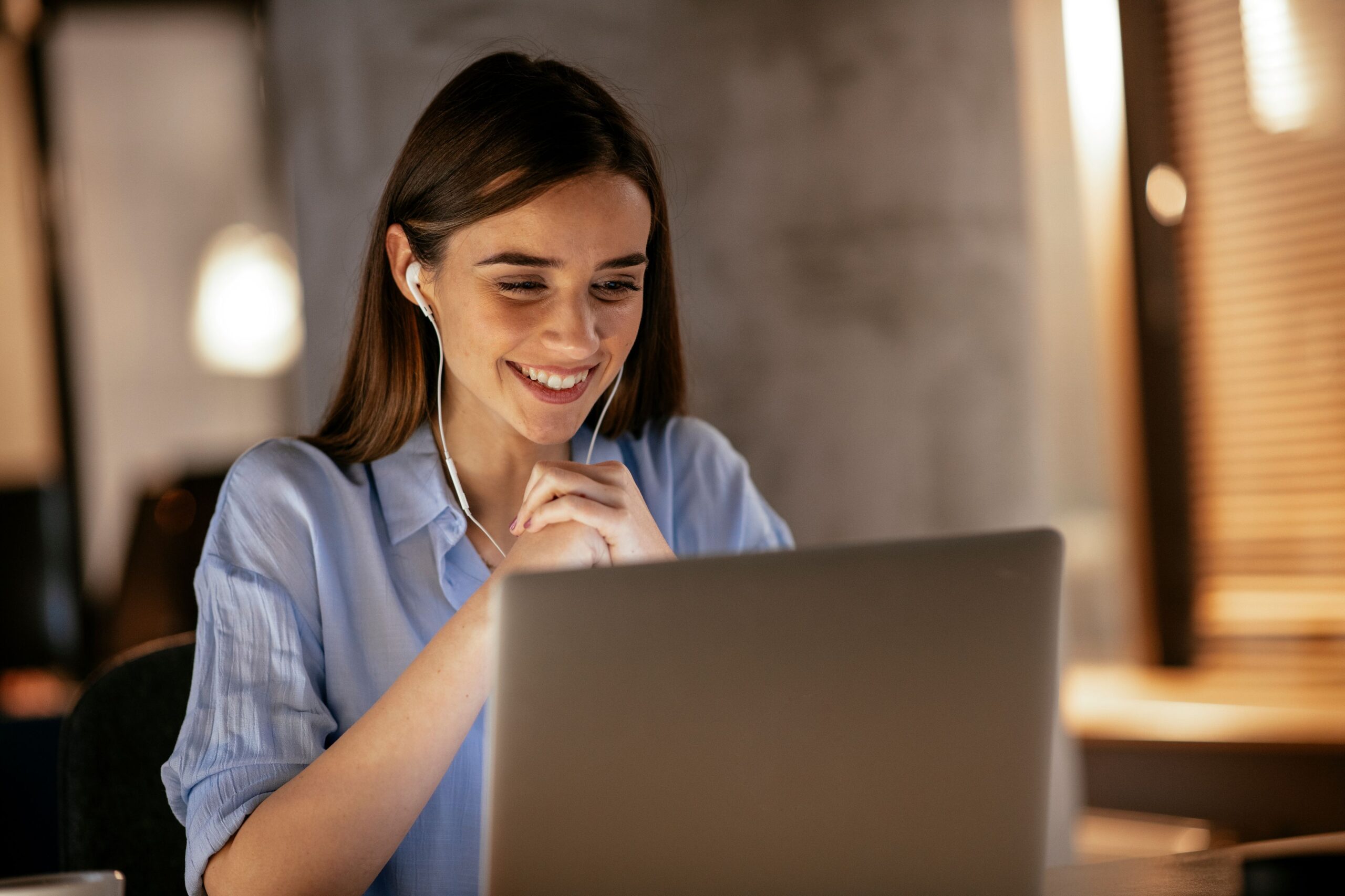 Junge Frau informiert sich online per Erklärvideo am Laptop